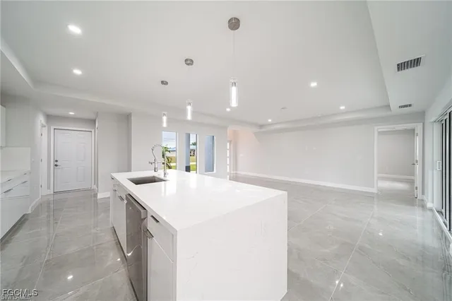 a kitchen with a sink and a refrigerator