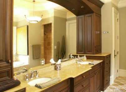 3120 Cone Manor Lane Raleigh, NC 27613 - Photo 11 of 11 Double granite vanities and cherry cabinetry in luxurious master bathroom