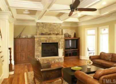 3120 Cone Manor Lane Raleigh, NC 27613 - Photo 6 of 11 Family room with stone fireplace, coffered ceilings and wall of French doors to covered patio