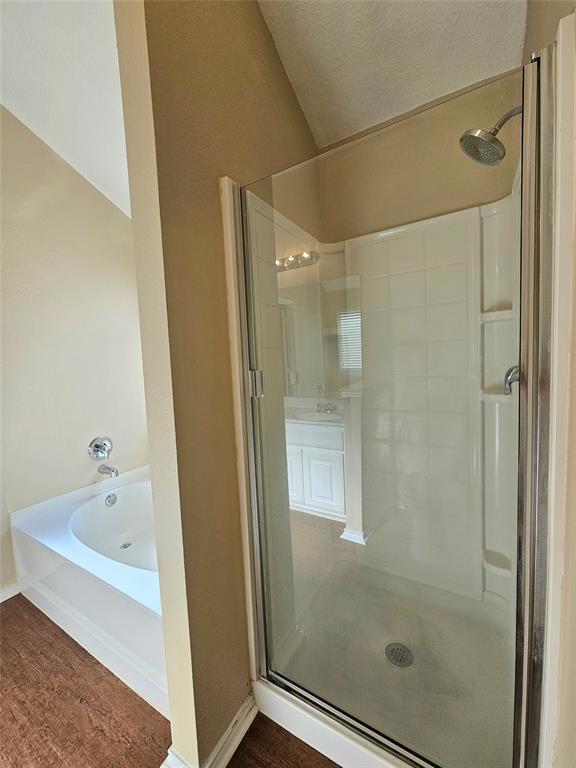 14224 Polo Ranch Street Fort Worth, TX 76052 - Photo 17 of 35 a bathroom with a bathtub and a shower