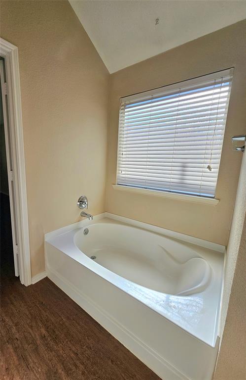 14224 Polo Ranch Street Fort Worth, TX 76052 - Photo 18 of 35 a spacious bathroom with a bathtub and a window