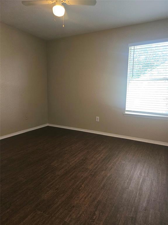 14224 Polo Ranch Street Fort Worth, TX 76052 - Photo 20 of 35 an empty room with wooden floor and windows