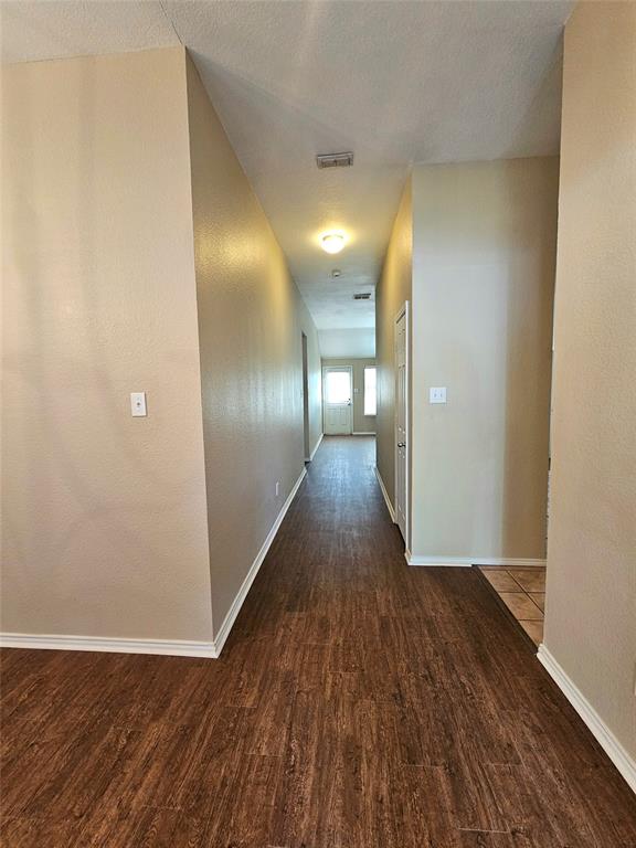 14224 Polo Ranch Street Fort Worth, TX 76052 - Photo 2 of 35 a view of a hallway with wooden floor