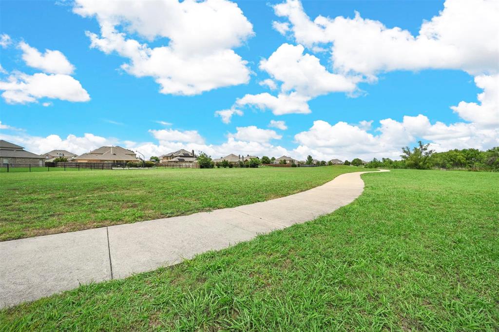14224 Polo Ranch Street Fort Worth, TX 76052 - Photo 34 of 35 a view of a golf course with a lake