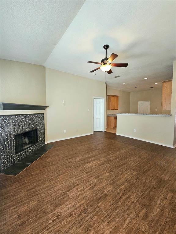 14224 Polo Ranch Street Fort Worth, TX 76052 - Photo 5 of 35 a view of an empty room with a fireplace and a chandelier fan