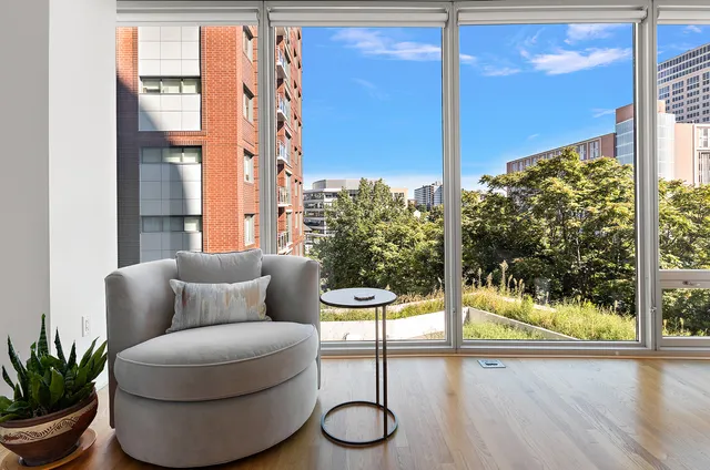 a living room with furniture and a floor to ceiling window