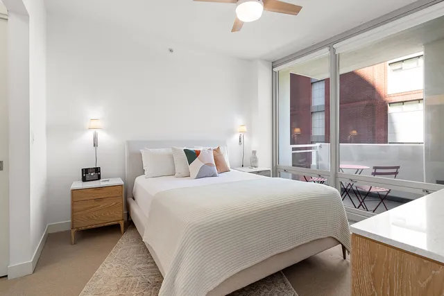 a bedroom with a bed and a chandelier