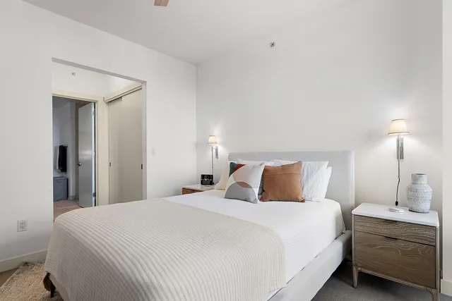 a bedroom with a bed and a night stand