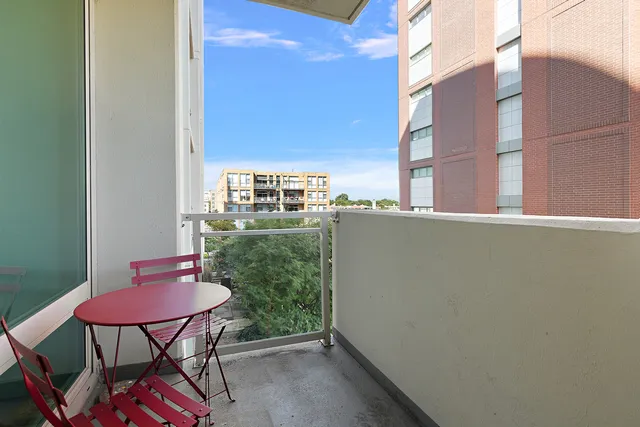 a view of a balcony with chairs and a table