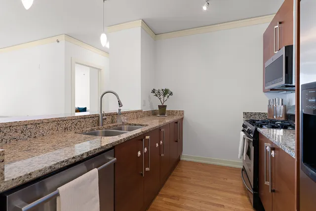 a kitchen with a sink and a stove top oven
