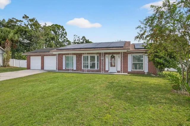 a view of a house with a backyard