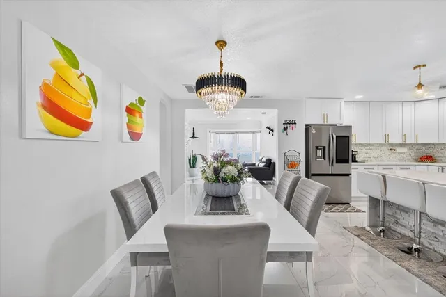 a bedroom with a bed and a flat tv screen on the dresser