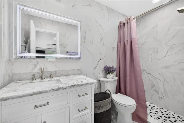 a balcony view with couple of couch and potted plants