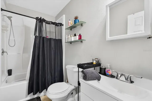 swimming pool view with a seating space and garden in the back