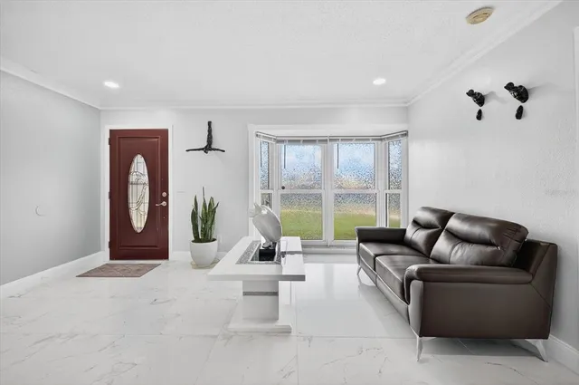 a living room with furniture a mirror and a chandelier