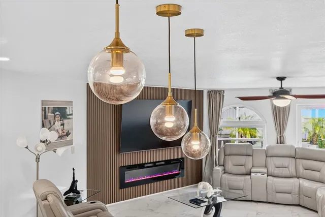 a kitchen with stainless steel appliances kitchen island granite countertop a table and chairs in it