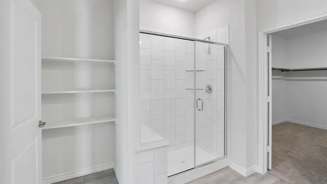 a bathroom with a glass shower door