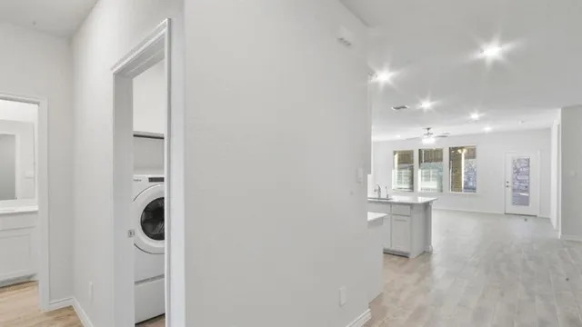 a view of entryway and hall with wooden floor