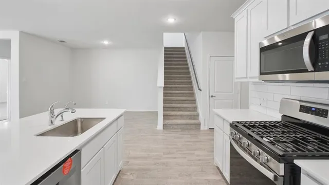 a kitchen with wooden cabinets and a stove top oven