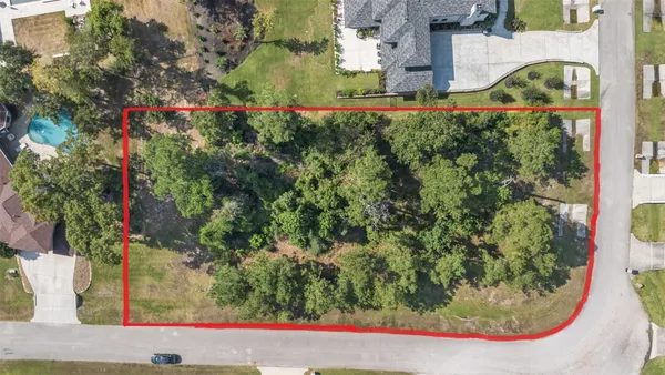 an aerial view of a house with a garden and lake view