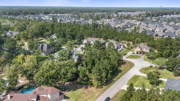 an aerial view of a house with a yard and garden