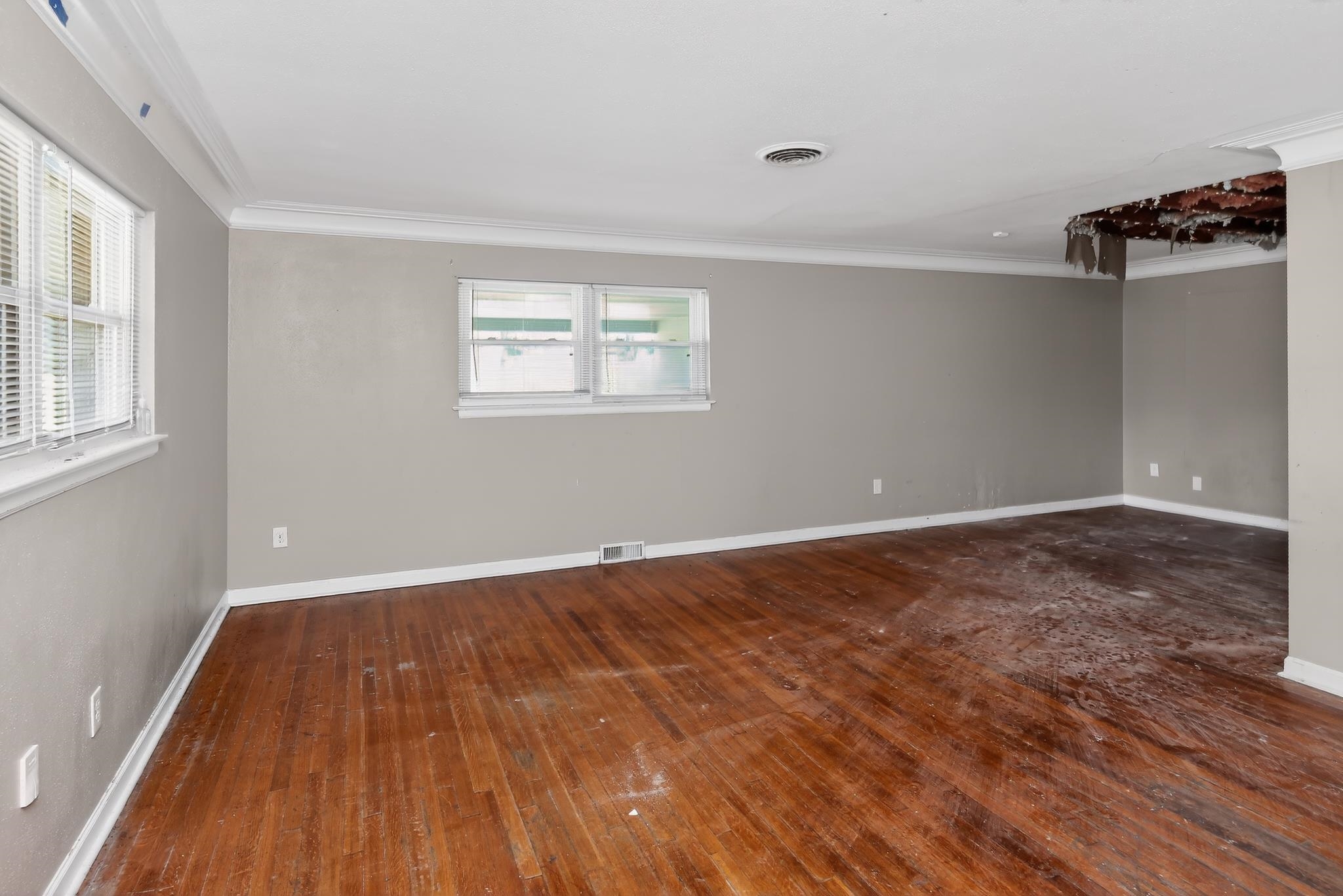 1403 Old Hickory Road Memphis, TN 38116 - Photo 10 of 31 Spacious interior featuring wood-finish flooring, light grey painted walls, white trim, and multiple windows with blinds