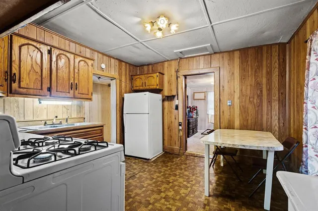 a kitchen with a stove a sink and a refrigerator