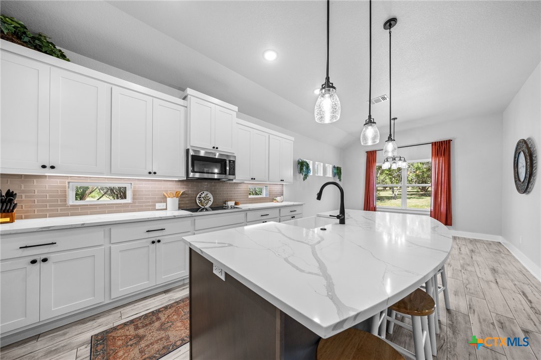 614 South Wheat Road Belton, TX 76513 - Photo 13 of 46 a kitchen with kitchen island a sink dining table and chairs