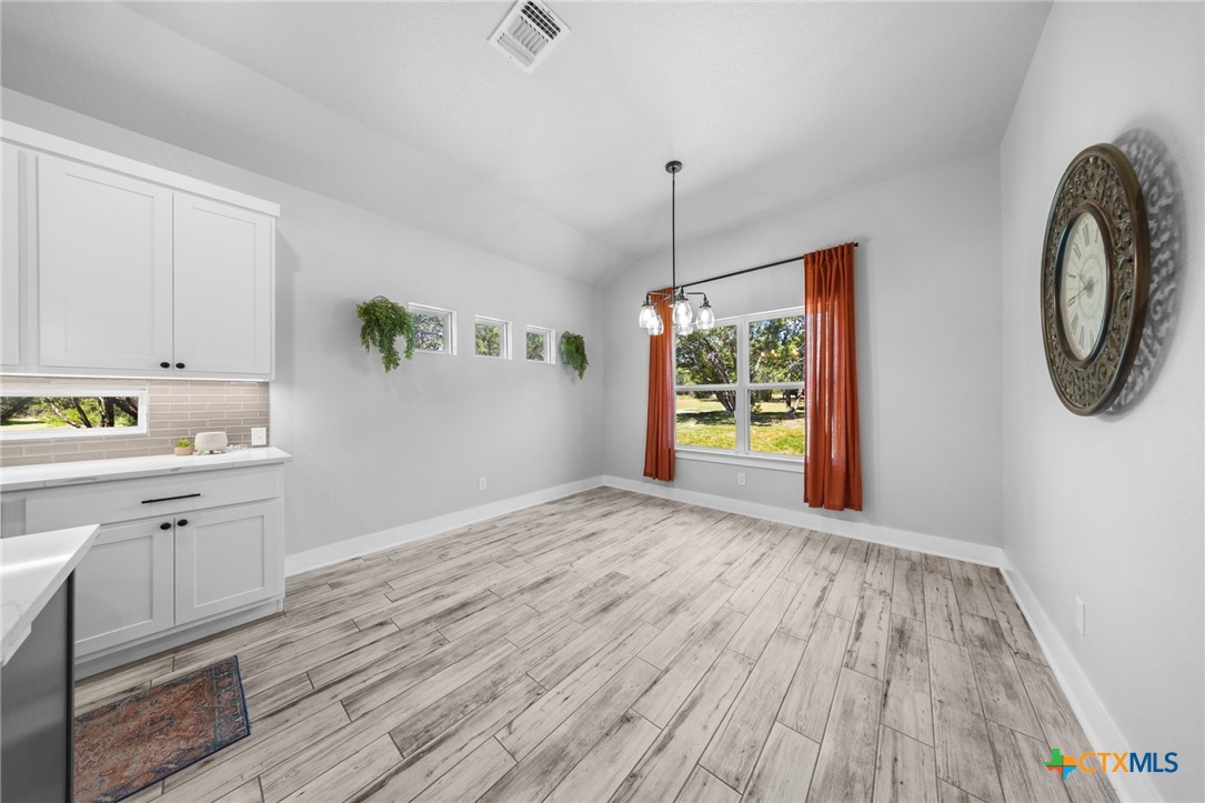614 South Wheat Road Belton, TX 76513 - Photo 14 of 46 a view of a kitchen with wooden floor electronic appliances and window