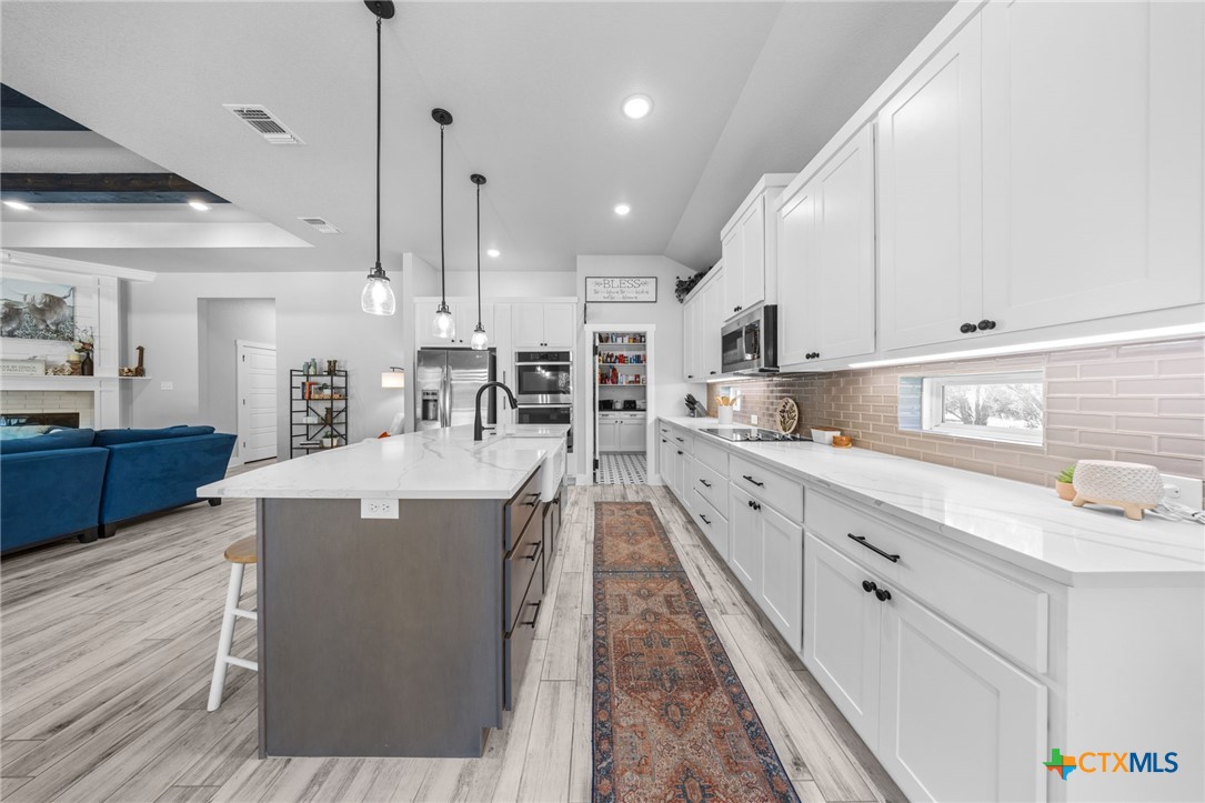 614 South Wheat Road Belton, TX 76513 - Photo 17 of 46 a large kitchen with stainless steel appliances kitchen island granite countertop a large island in the center