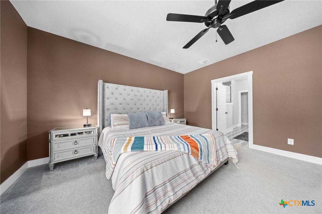 614 South Wheat Road Belton, TX 76513 - Photo 21 of 46 a bedroom with a bed and a ceiling fan