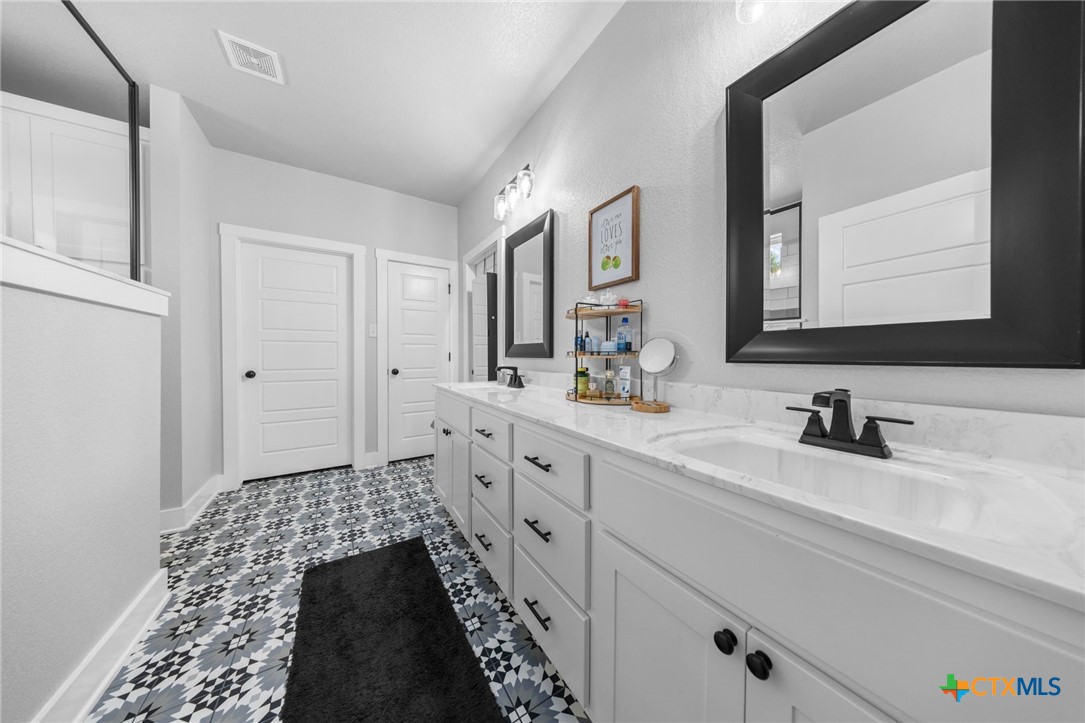 614 South Wheat Road Belton, TX 76513 - Photo 23 of 46 a spacious bathroom with double vanity and a mirror