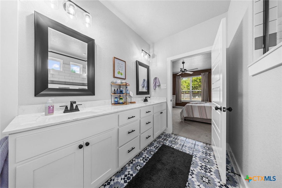 614 South Wheat Road Belton, TX 76513 - Photo 26 of 46 a bathroom with a double vanity sink mirror and bathtub