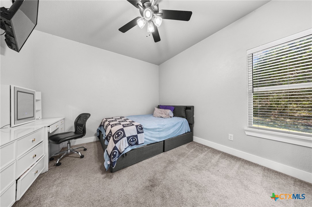 614 South Wheat Road Belton, TX 76513 - Photo 33 of 46 a bedroom with a bed a desk and chair