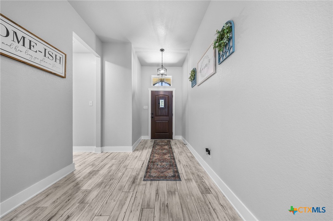 614 South Wheat Road Belton, TX 76513 - Photo 5 of 46 a view of a hallway with wooden floor