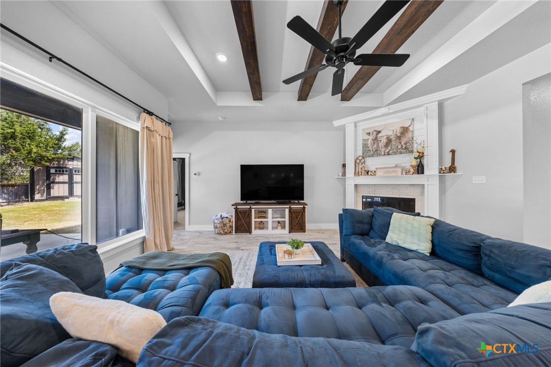 614 South Wheat Road Belton, TX 76513 - Photo 9 of 46 a living room with furniture a flat screen tv and a large window
