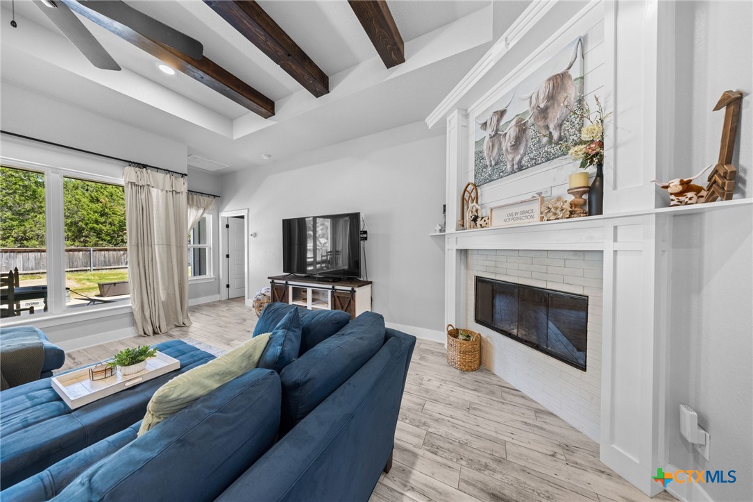 614 South Wheat Road Belton, TX 76513 - Photo 10 of 46 a living room with furniture a flat screen tv and a fireplace