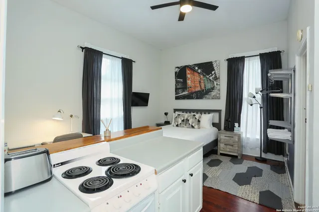 a kitchen with a refrigerator and a stove top oven
