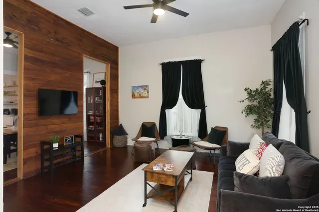 a living room with furniture and a flat screen tv