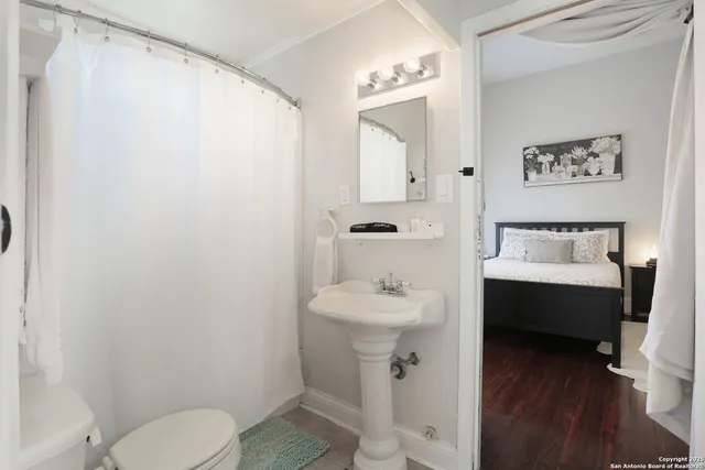 a bedroom with a large bed and a large mirror