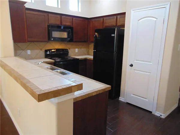 a kitchen with a refrigerator and a stove