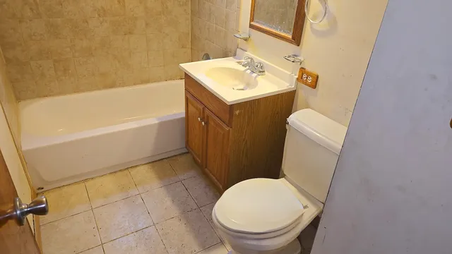 a bathroom with a sink a toilet and bathtub