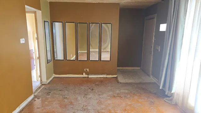 a view of an empty room with windows