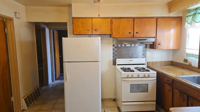 a kitchen with a refrigerator stove and microwave