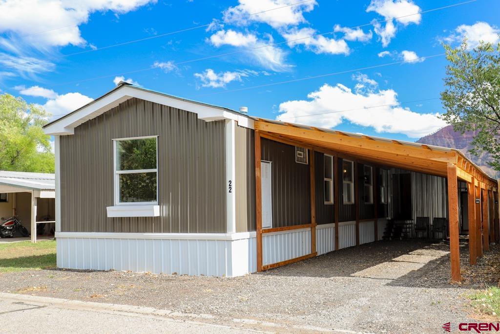 a view of a house with a backyard