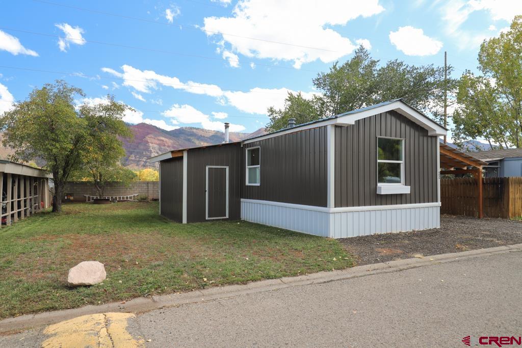 22 Huckleberry Lane Durango, CO 81301 - Photo 2 of 24 a front view of a house with a yard and garage