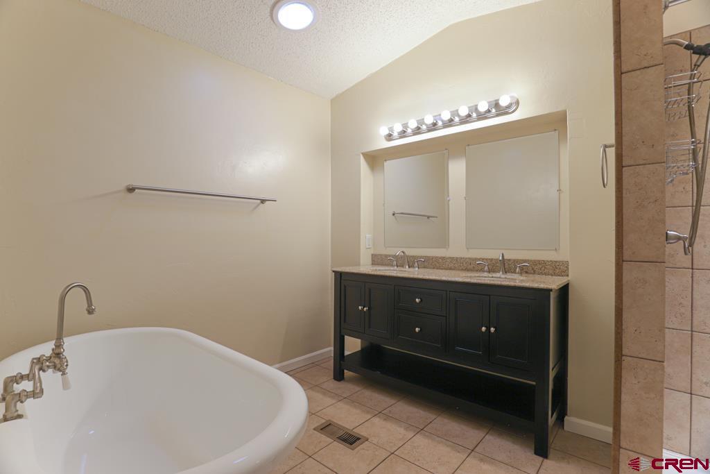 22 Huckleberry Lane Durango, CO 81301 - Photo 11 of 24 a bathroom with a bathtub and a sink