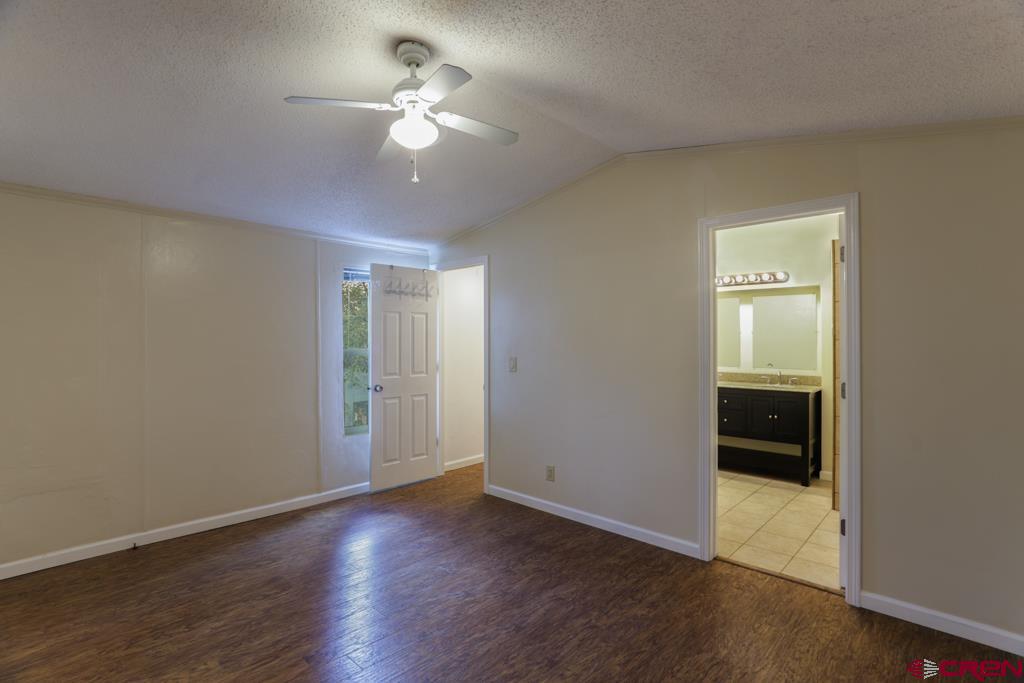22 Huckleberry Lane Durango, CO 81301 - Photo 10 of 24 an empty room with wooden floor and ceiling fan