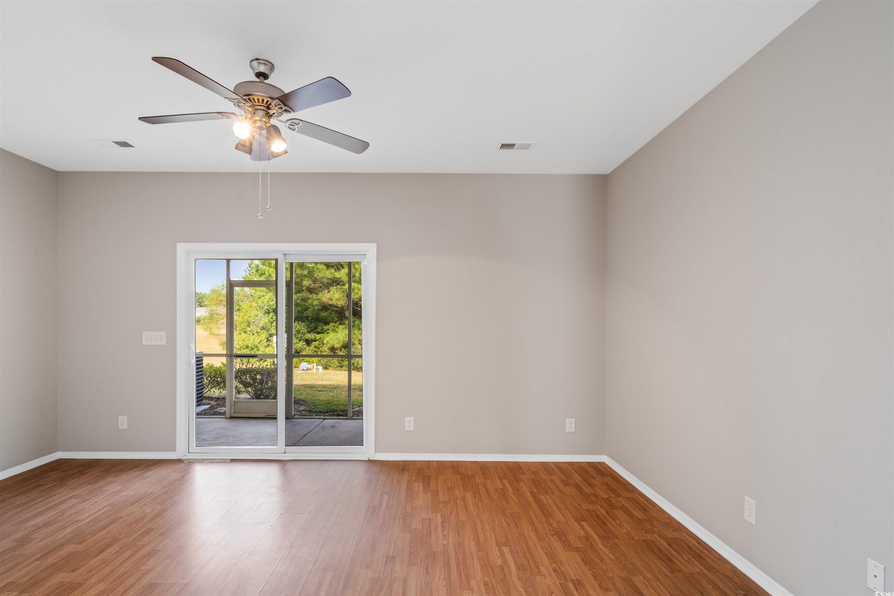 350 Kiskadee Loop, Unit B Conway, SC 29526 - Photo 5 of 40 Empty room with ceiling fan and hardwood / wood-st