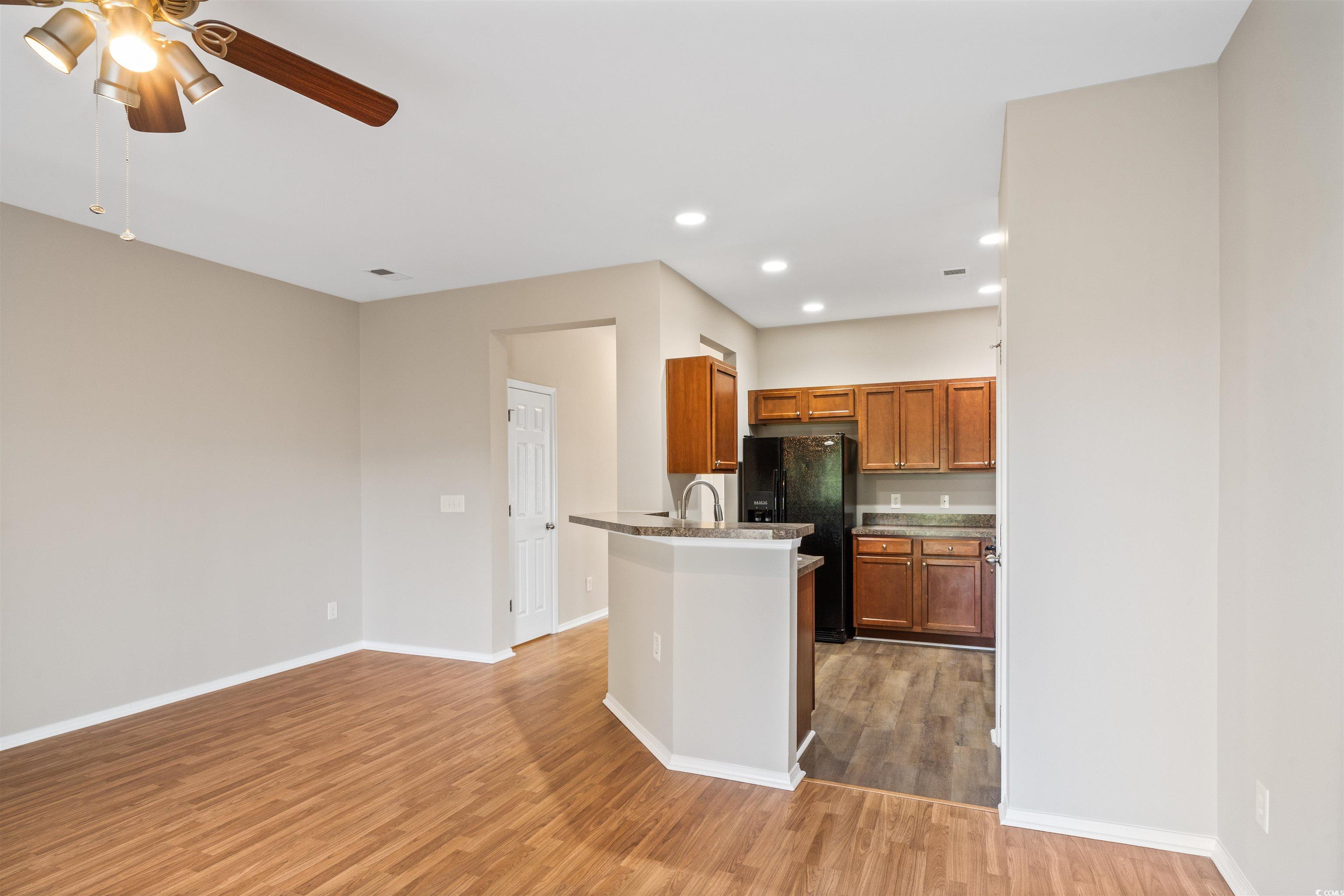 350 Kiskadee Loop, Unit B Conway, SC 29526 - Photo 7 of 40 Kitchen featuring black fridge, light wood-type fl
